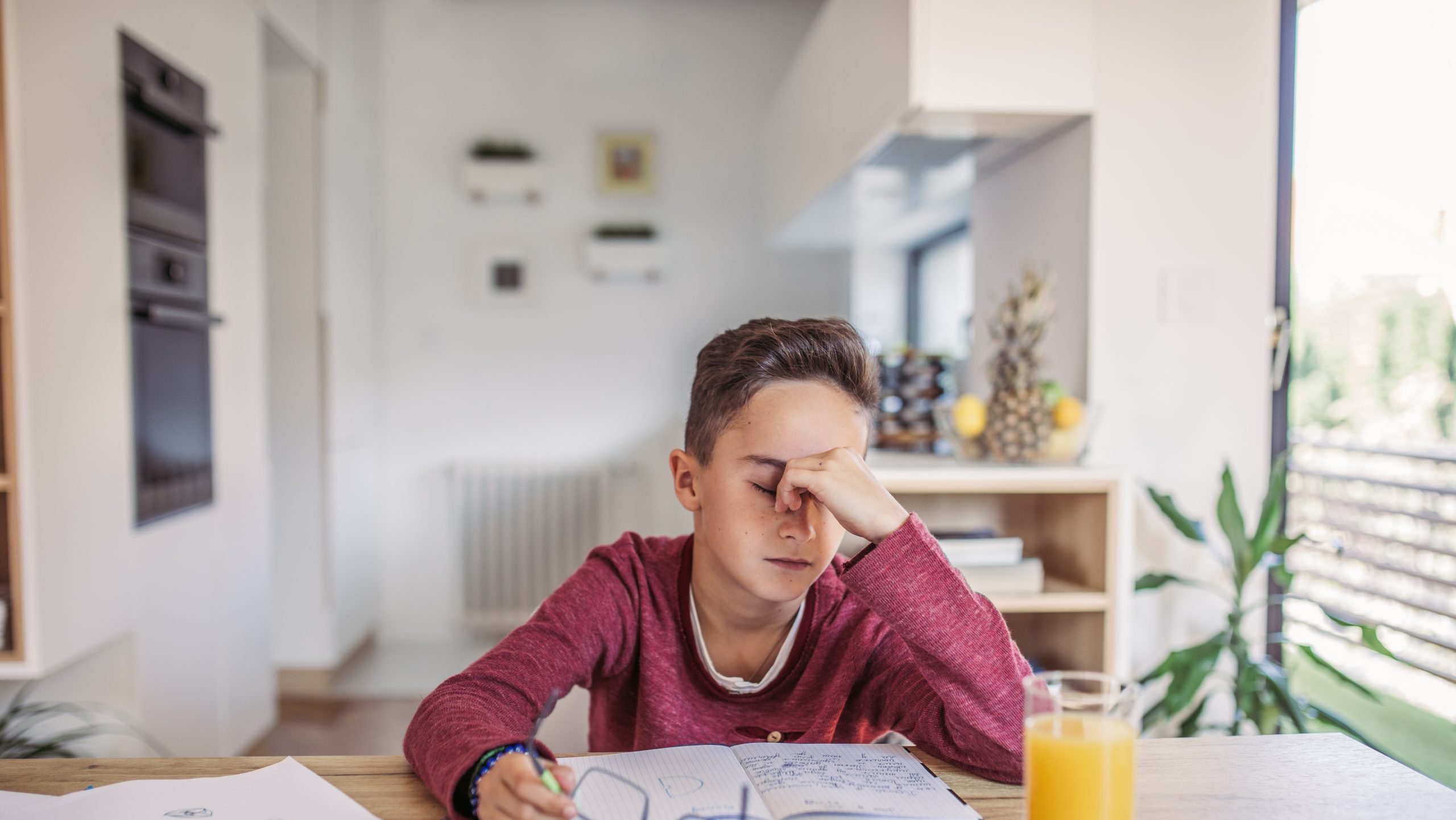 Young boy tired of doing his homework