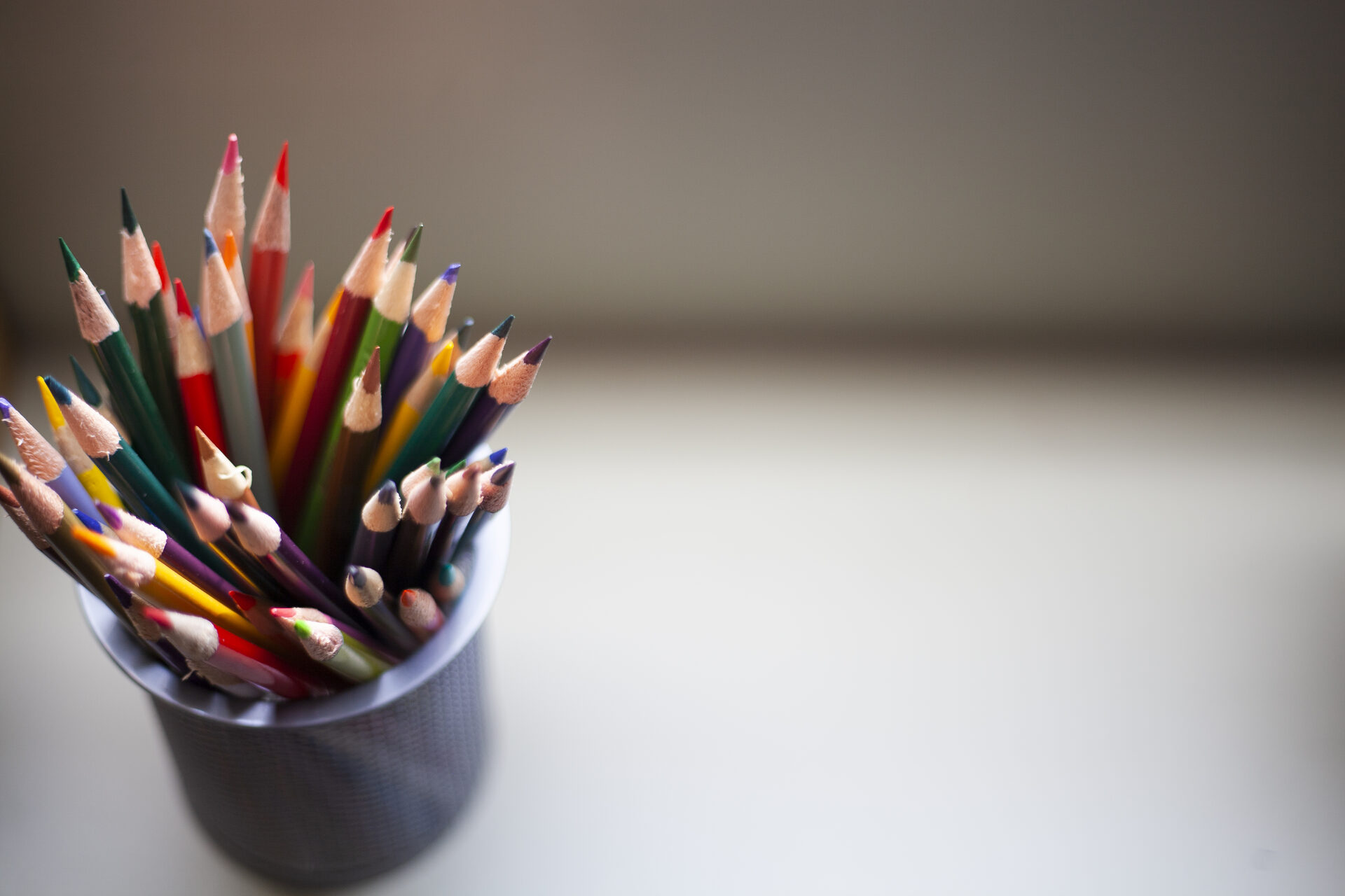 Coloured pencils in a cup on a desk at Novaread learning centre