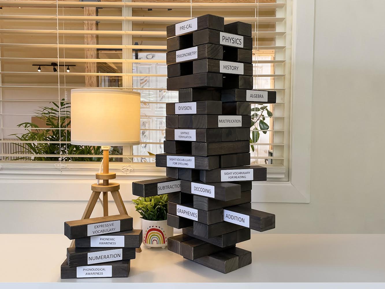 Jenga tower illustrating bottom-up remediation — strong learning foundations prevent academic collapse | Novaread Halifax & Bedford