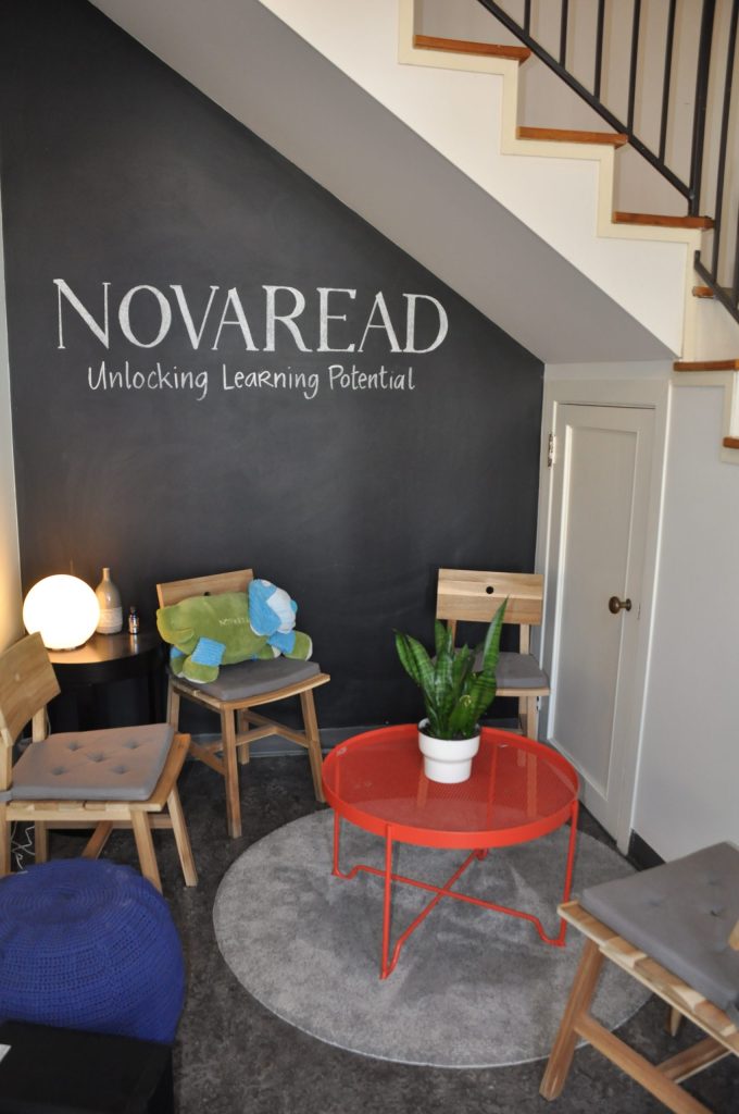 Welcoming waiting area at the Novaread clinic with chalkboard wall reading Novaread — Unlocking Learning Potential