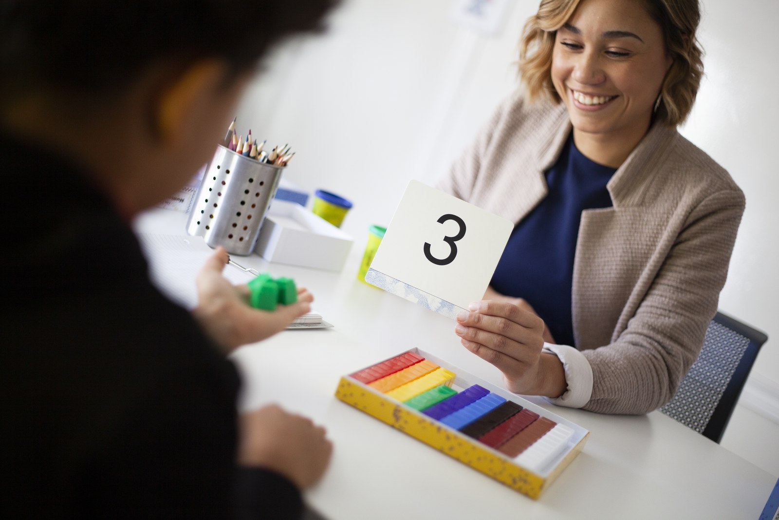 Student working with math manipulatives and a numeral card at Novaread